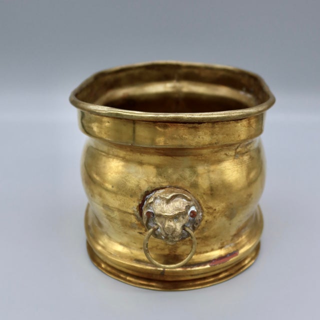 A well-loved vintage oval cachepot with a pair of lion-mask ring handles adding real character to an otherwise simple...