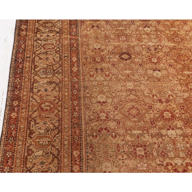 An early 20th century Indian Amritsar carpet, the beige field with a dense allover trellis design of flowerheads and...