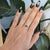 An indicolite tourmaline in a deep ocean blue anchors this solid 14K white gold ring, accented by four earth-mined...