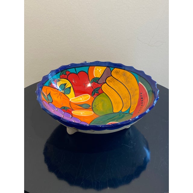 Elevate your kitchen or dining space with this stunning, generously sized fruit bowl, a vibrant testament to Mexican folk...