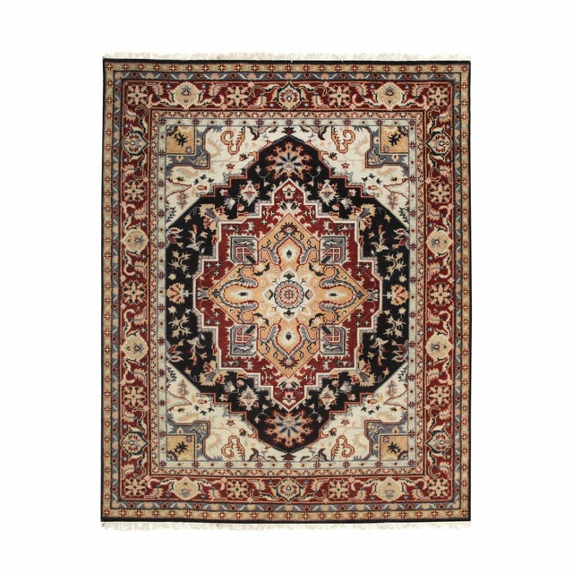 A hand-knotted wool rug, made in India and measuring 2'6"' x 10'. A centre medallion anchoring the field, framed by a...