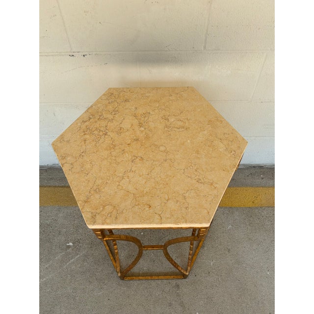 Modern Roja hexagonal marble and iron side table, ribbed frame finished in gold with a beige top, showroom floor sample