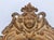 This mirror has foliate designs with a crest that has a lady’s portrait. There is a mellow gold finish and the slightly...