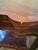 A beautifully crafted Maitland-Smith occasional table featuring a shaped serpentine top in flame mahogany veneer,...