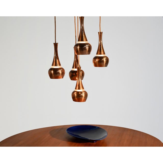 Copper and glass pendant lamp, composed of five pendant shades. Attributed to Staff, Germany, 1960s. Composed of five...