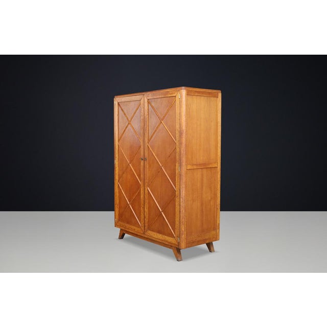 A beautifully proportioned French mid-century wardrobe crafted in blond oak and distinguished by its striking geometric...