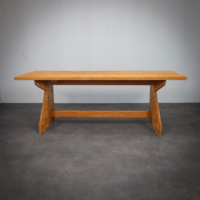 This dining table, designed by jacob kielland brandt and produced by christiansen in denmark during the 1960s, reflects...