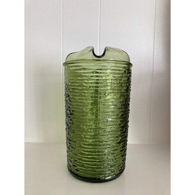 Anchor Hocking “Soreno” Pitcher in avocado green. Produced 1966-1970. It is heavy, sturdy with textured horizontal ribs....