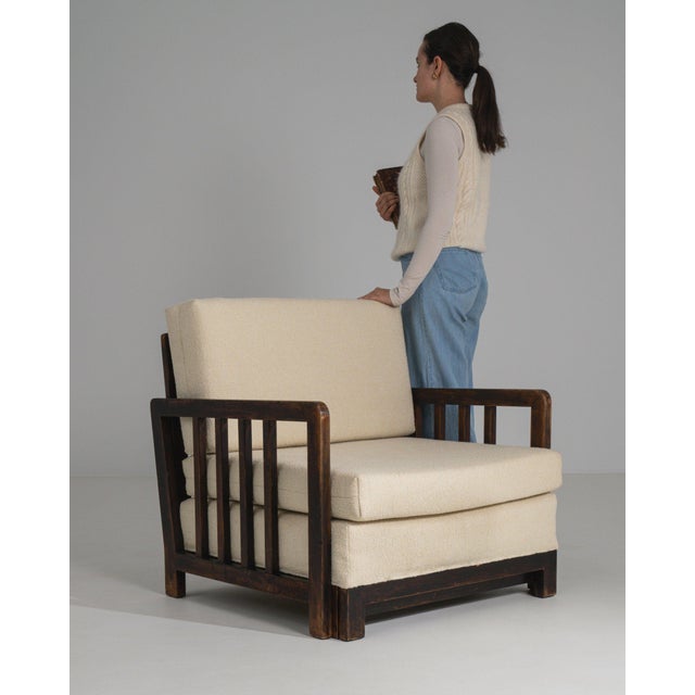 This sofa makes its impression through cream boucle upholstery, dark wood frame edge. Dating to Early 20th Century and...