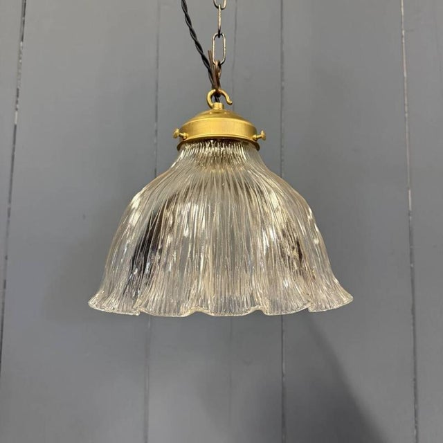 Beautiful medium-sized pressed glass Holophane pendant lamp from France, 1930s. Fitted with a brass fixture with an E27...