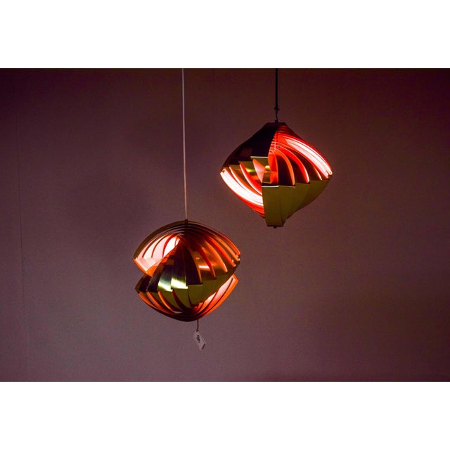 Pair of Lyfa Konkylie pendant lamp, 12 folded anodised oval aluminium spiral slats lampshade and some metal parts. This...