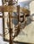 Elegant vintage metal hall stand with a warm gilt-toned finish, decorative scrollwork, and a beautifully ornate...