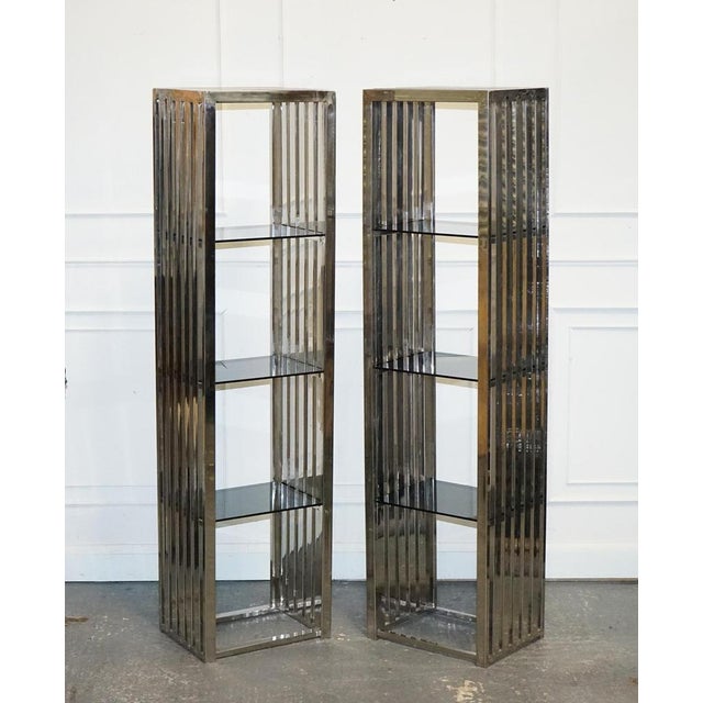 Stunning Casa Padrino Stainless Steel Pair Of Bookcases And Smoked Glass Shelf. The Casa Padrino stainless steel pair of...