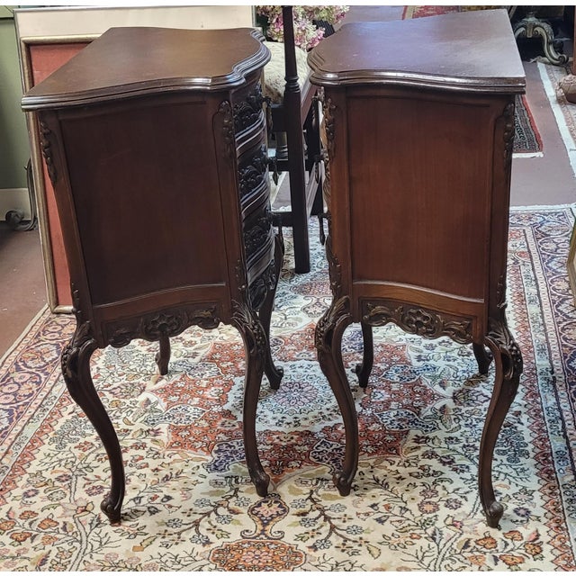 Fine pair of highly carved 1920s swan leg end tables. Each features serpentine shaped bodies, slender legs, highly carved...