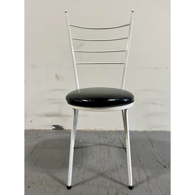 Sleek modern wrought iron chairs in the style of Paul McCobb. Great period look with high slender ladder backs and ball...