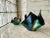 Signed handkerchief ribbon vases by Ron Le Jueau in black carnival glass with a lustrous iridescent finish. Each piece is...