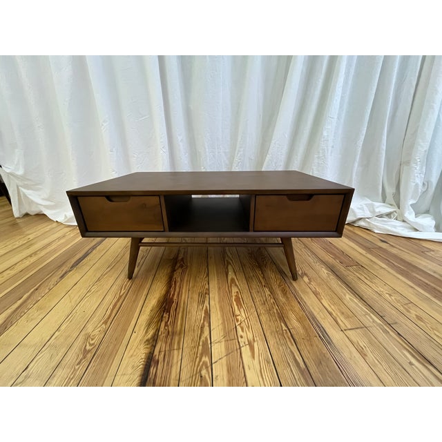 The Jake Coffee Table by the premier high-end manufacturer Nuevo Living is a beautiful exploration of retro-inspired...