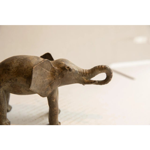 :: Vintage handmade African elephant eating sculpture. Circa late mid 20th century, though possibly older, this piece has...