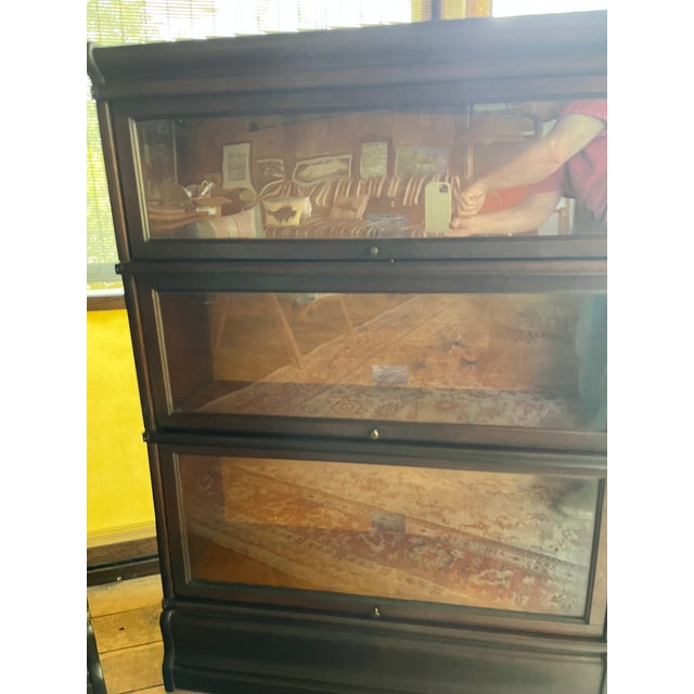 Matched pair of three unit Globe Wernicke solid mahogany bookcases with original bases and tops. Original glass in the...