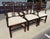 This set of six mahogany Chippendale-style dining chairs features graceful pierced splat backs, carved crest rails, and a...