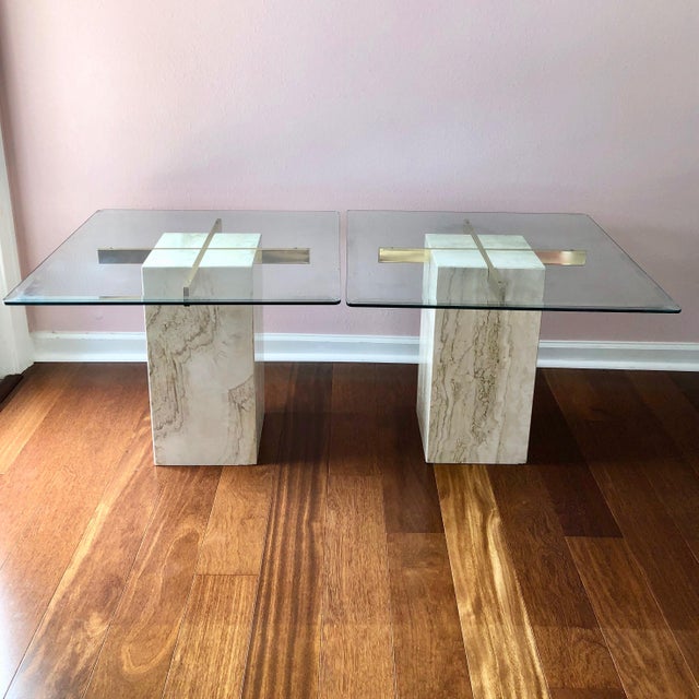 Gorgeous pair of travertine, brass and glass topped end tables. Made in Italy, circa 70s for Artedi. The glass tops are...