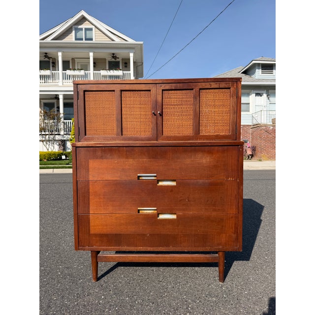 Mid century Merton Gershun highboy dresser for Martinsville. The dresser features 5 drawers with cane doors and aluminum...