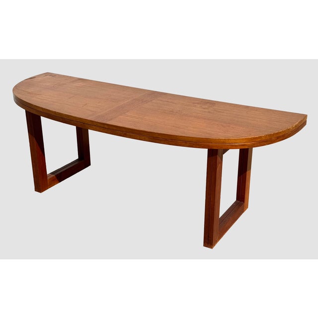 A mid-century Danish modern oval coffee table by Beni Mobler, Denmark. Features a table top that folds in half., and the...