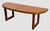 A mid-century Danish modern oval coffee table by Beni Mobler, Denmark. Features a table top that folds in half., and the...