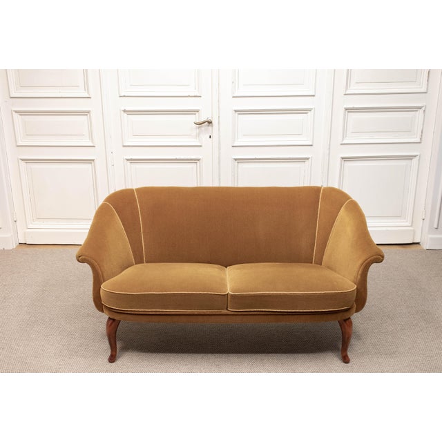 1940s Swedish two-seater sofa upholstered in bronze-coloured velour. The design features softly curved lines, elegantly...