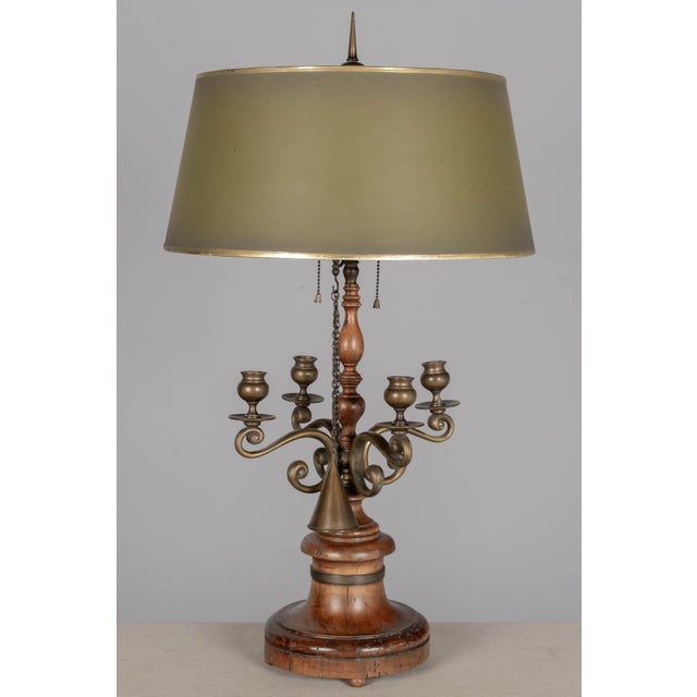 A vintage Italian bouillotte style lamp made in Italy by The Champman Manufacturing Company. Turned wood base with brass...