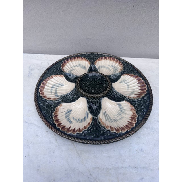 Green Majolica oyster plate, six white wells on a green basket weave, circa 1890 signed Longchamp.