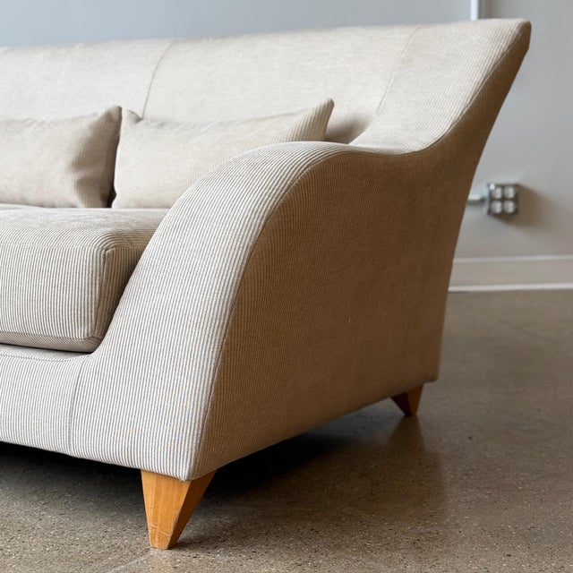 c. 2000s. USA. Tagged. Reupholstered in stone grey corduroy. Original wood legs that match sofa form.