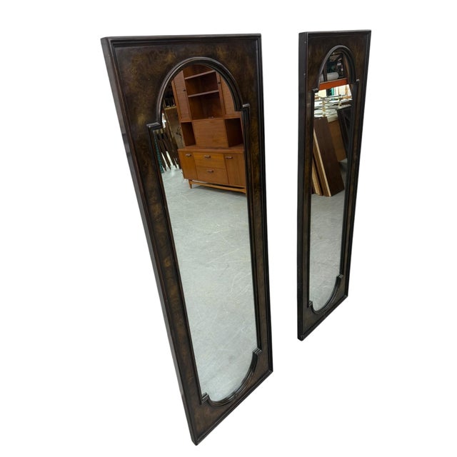 Elevate your interior with this stunning pair of vintage circa 1970s Mastercraft burled wood mirrors, showcasing the...