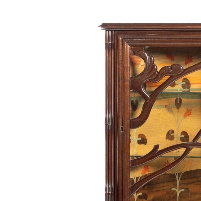 Furniture - Art Nouveau corner display cabinet (signed). French; early 20th century; in mahogany and other woods with one...