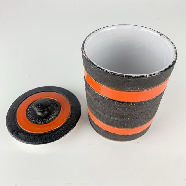 Nice vintage pottery canister with lid. Love the texture and orange and brown stripes. Made in Italy. Signed on bottom....