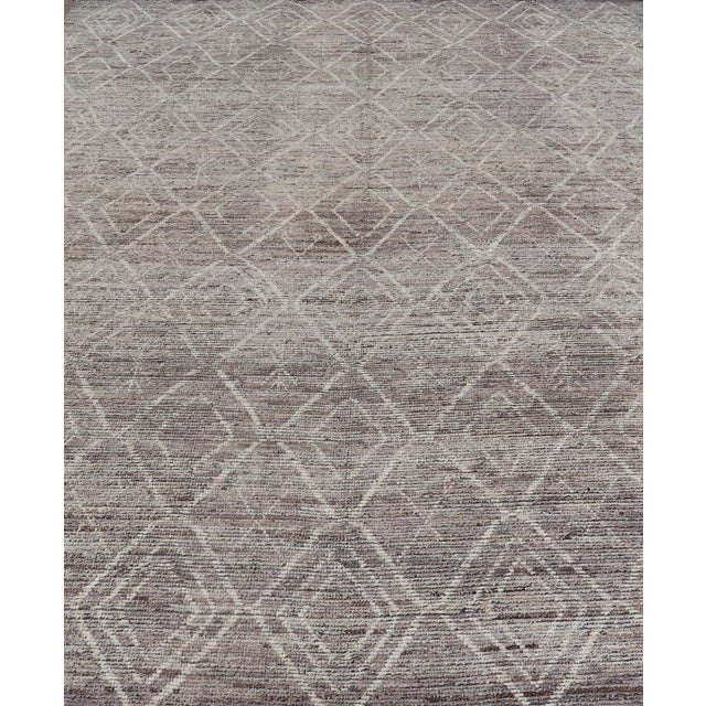 This modern casual rug has been hand-knotted. The rug features a geometric Moroccan diamond design, replete with various...