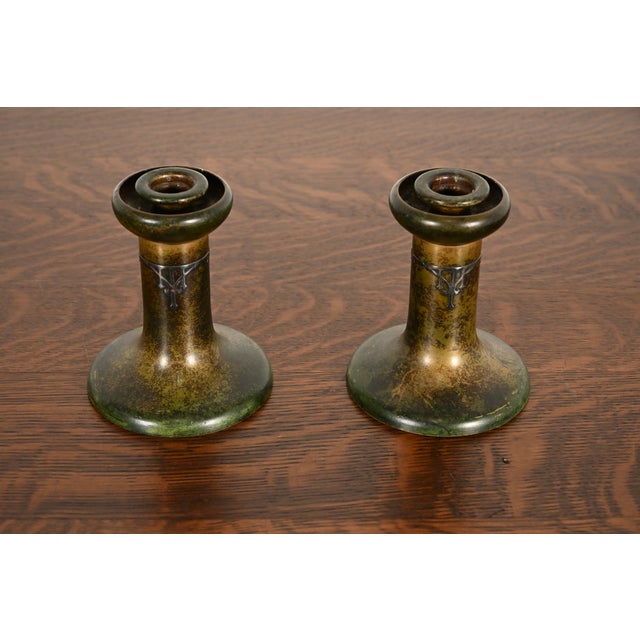 A gorgeous pair of antique Arts & Crafts period sterling silver on bronze candlesticks By Heintz Art Metal Shop USA, Early...