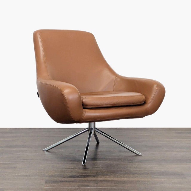 This stylish brown leather lounge chair from Design Within Reach features a comfortable, wide seat and sleek metal swivel...
