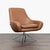 This stylish brown leather lounge chair from Design Within Reach features a comfortable, wide seat and sleek metal swivel...