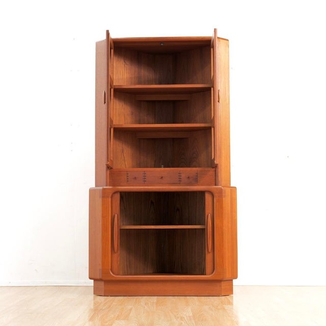 This fabulous mid century corner cabinet was manufactured and designed by Dyrlund of Denmark. Produced in teak, this...