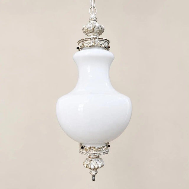 Large milk glass swag lamp with a sculptural globe and ornate white-and-gold fittings. Measures 27″ tall, with new wiring,...