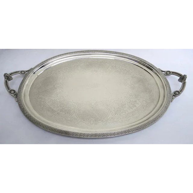 Dramatic large silver plated tray with faces on handles. Greek key border. Measures 30 1/2" by 19". Good vintage...