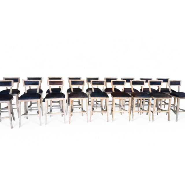 Elevate your space with this elegant bar stool, featuring a sturdy oak wood frame paired with a luxurious cowhide...