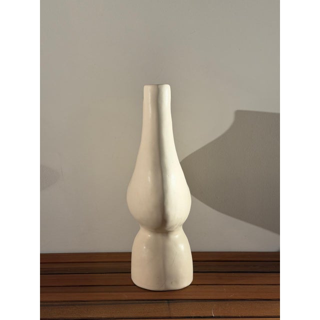 A sculptural double-neck vessel by Brooklyn ceramicist Simone Bodmer-Turner: two necks joined by an arch, an open hole...