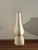 A sculptural double-neck vessel by Brooklyn ceramicist Simone Bodmer-Turner: two necks joined by an arch, an open hole...