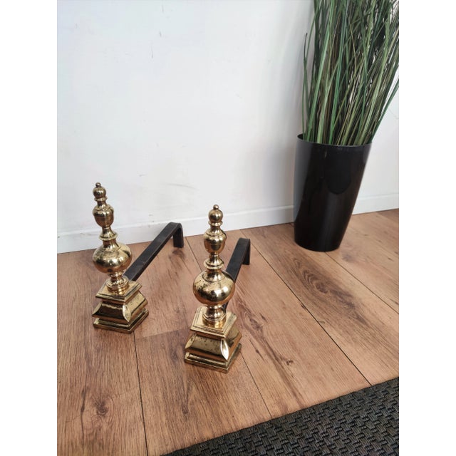 Pair of Mid-century wrought iron and brass Italian andirons, having a beautiful neoclassical shaped shiny brass front and...