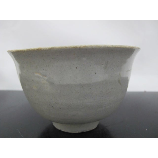 Chinese Longquan Celadon pottery bowl. Jade green glazed pottery vessel with irregular shape on footed base. Originated in...