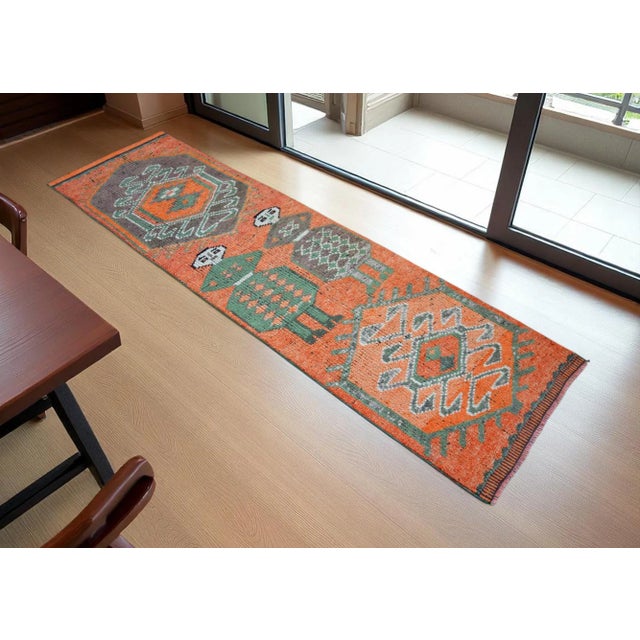 Woven in the 1960s in the Southeastern Anatolia region of Turkey, this extraordinary runner rug stands as a gallery-...