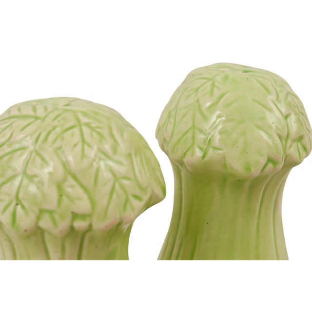 A pair of ceramic Japanese salt and pepper shakers, shaped like White Bok Choi or ‘Chinese Cabbage’. Tops decorated with...