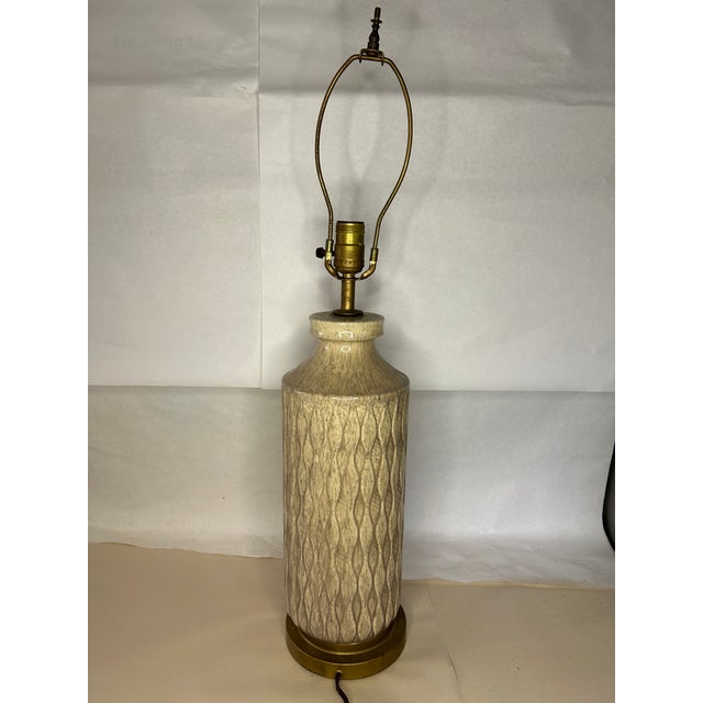 **Description:** Elegant vintage French table lamp featuring a beautifully glazed porcelain body with an embossed...